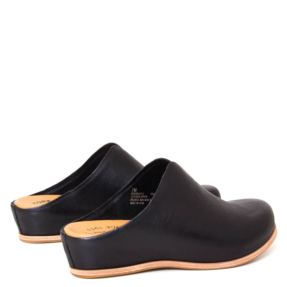 Kork-Ease Para. Women's wedge mule in black leather. Heel Height: 1 1/2 Inches and Wedge Height: 1/2 Inch. Back view.