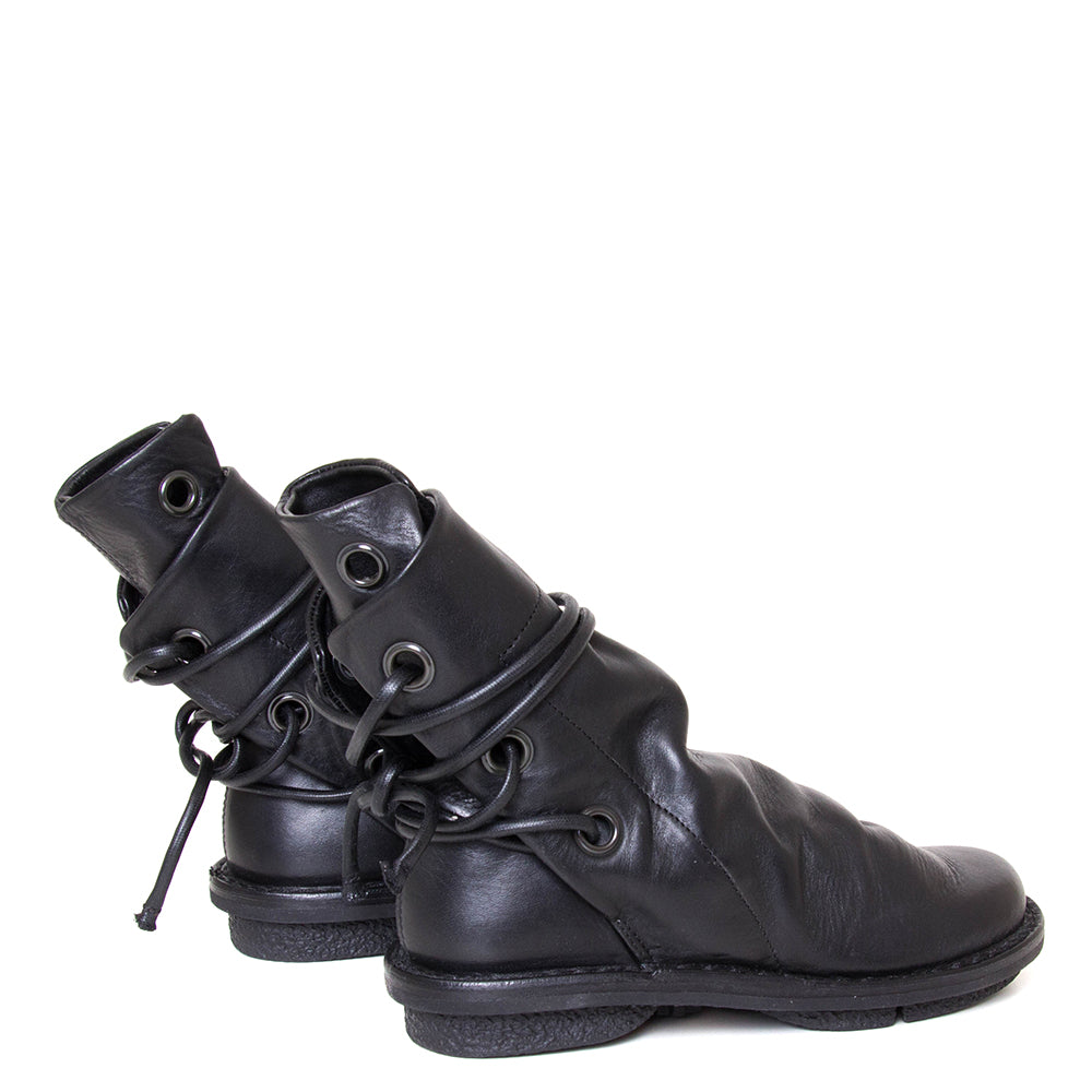 Trippen Awning. Women's leather slip-on, ankle boot in black leather, wrap-around laces. Made in Germany. Back view.