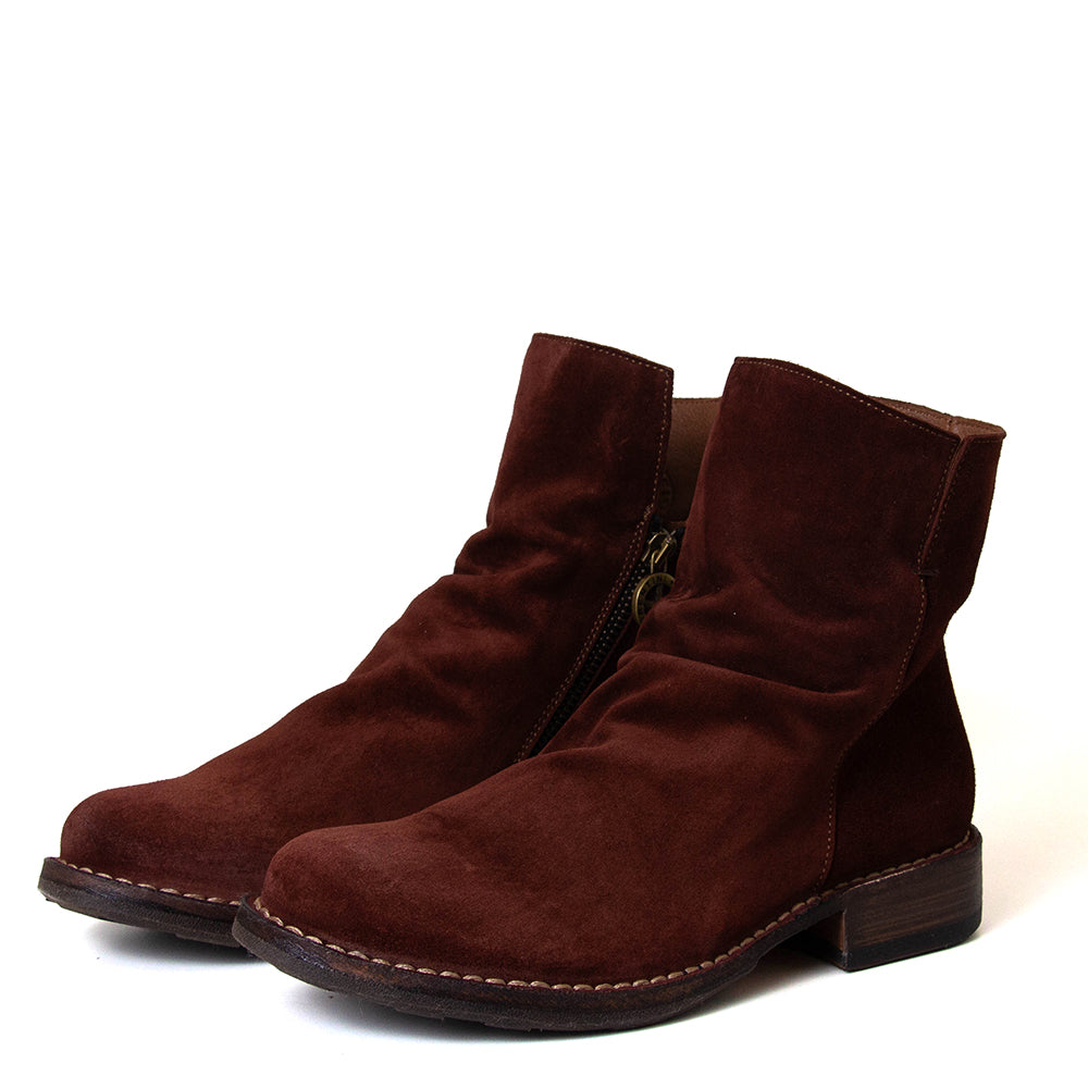 Pair of brown suede ankle boots on a white background