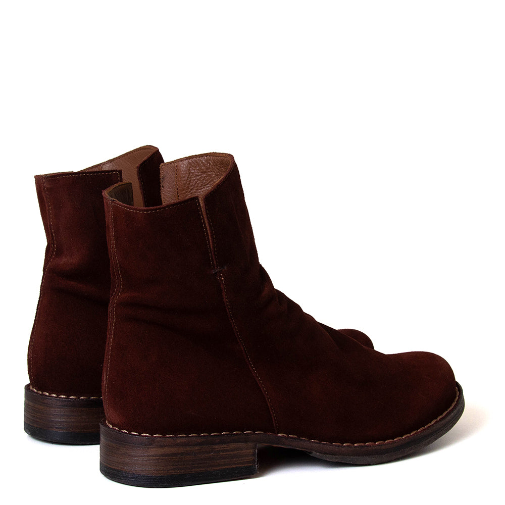 Pair of brown suede ankle boots on a white background