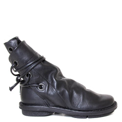 Trippen Awning. Women's leather slip-on, ankle boot in black leather, wrap-around laces. Made in Germany. Side view.
