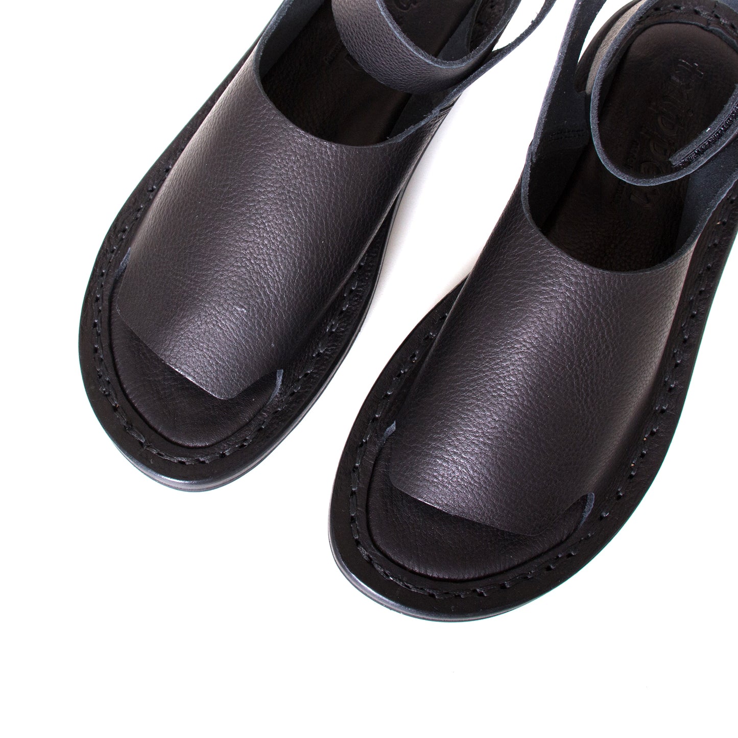 Trippen Hug. Women's sandal in Black leather, rubber sole, ankle strap with velcro for a secure fit. Made in Germany. Top view, pair.