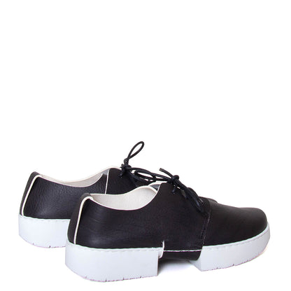 Trippen Office. Women's leather shoe in black leather with white sole. Made in Germany. Back pair view.