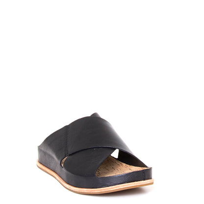 Kork-Ease Tutsi Cross-Band. Women's slide sandals in black criss-cross leather straps. Cushioned anatomical cork footbed for comfort and arch support. 1-inch flat heel. Front view.